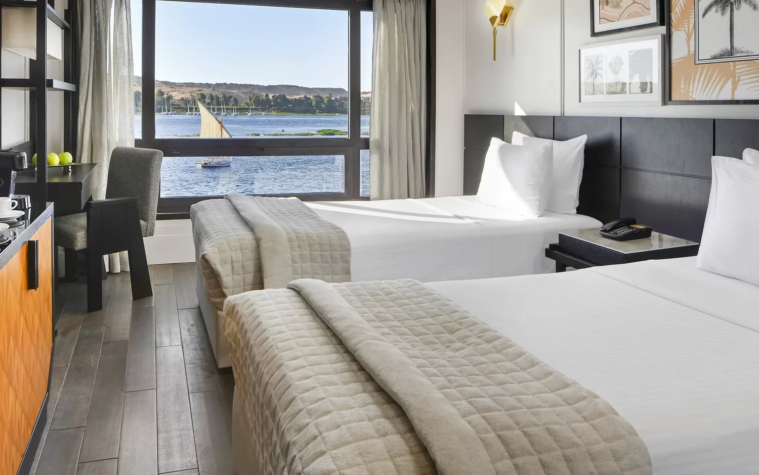 Crucero por el Nilo del lujo Mövenpick MS Sun Ray habitación con vistas panorámicas al Nilo.